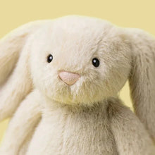 Close-up of a plush bunny toy with a yellow background
