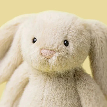 Close-up of a plush bunny toy with a yellow background