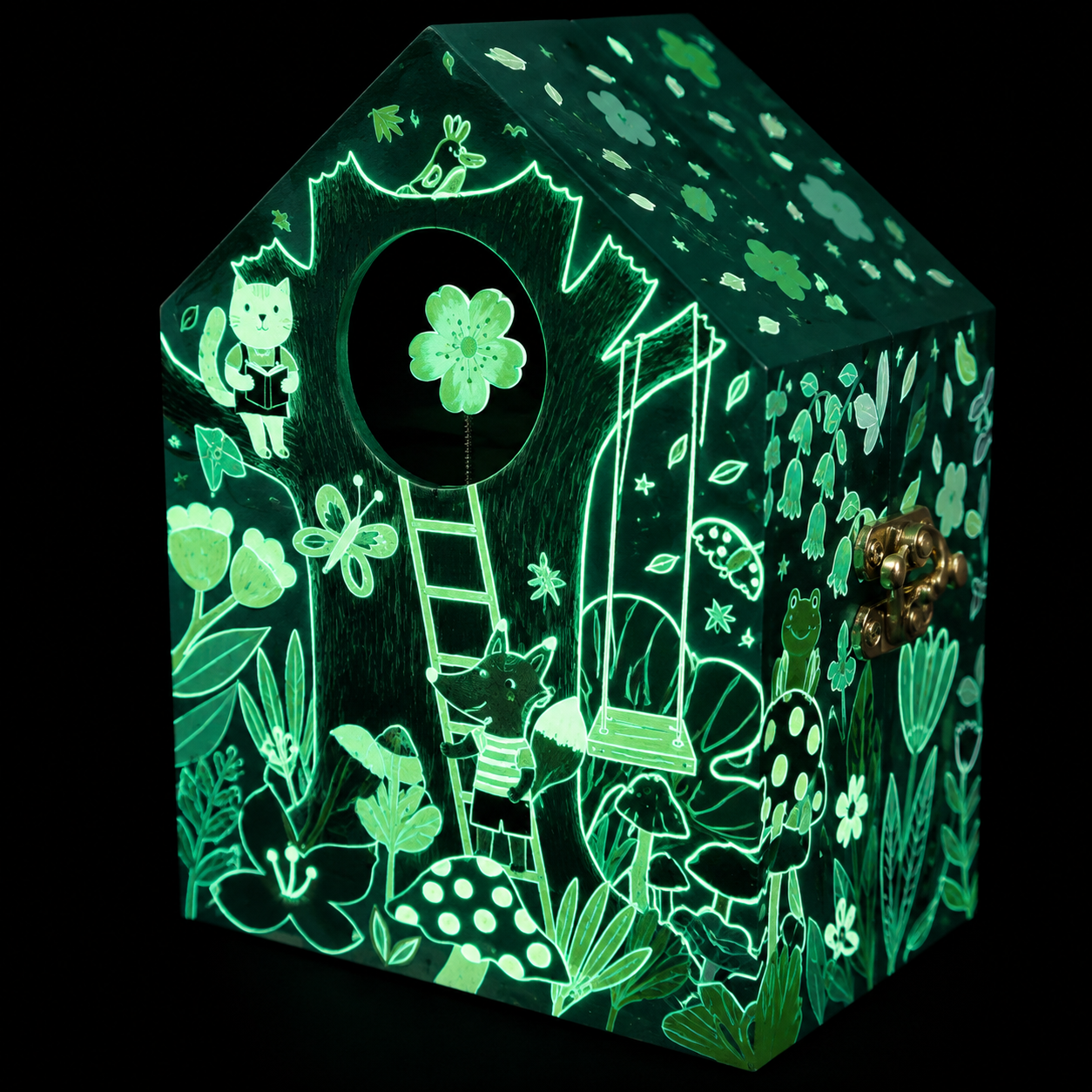 A glowing green wooden house-shaped box with intricate forest illustrations, including a ladder, mushrooms, flowers, and small animal characters, shown against a black background.