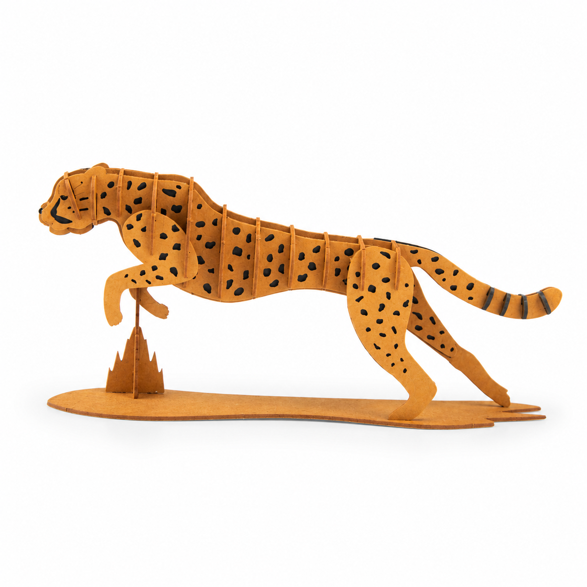 A 3D wooden model of a cheetah in a running pose, standing on a small abstract mountain structure, set against a plain white background.