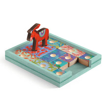 A colorful board game featuring a red donkey piece and various game pieces with floral patterns on a teal board.