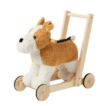 A plush dog walker with a wooden frame and wheels, designed for assisting toddlers with mobility and sitting-to-stand movements.