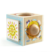 A colorful wooden baby activity toy designed as a cube with various openings and a ball inside.
