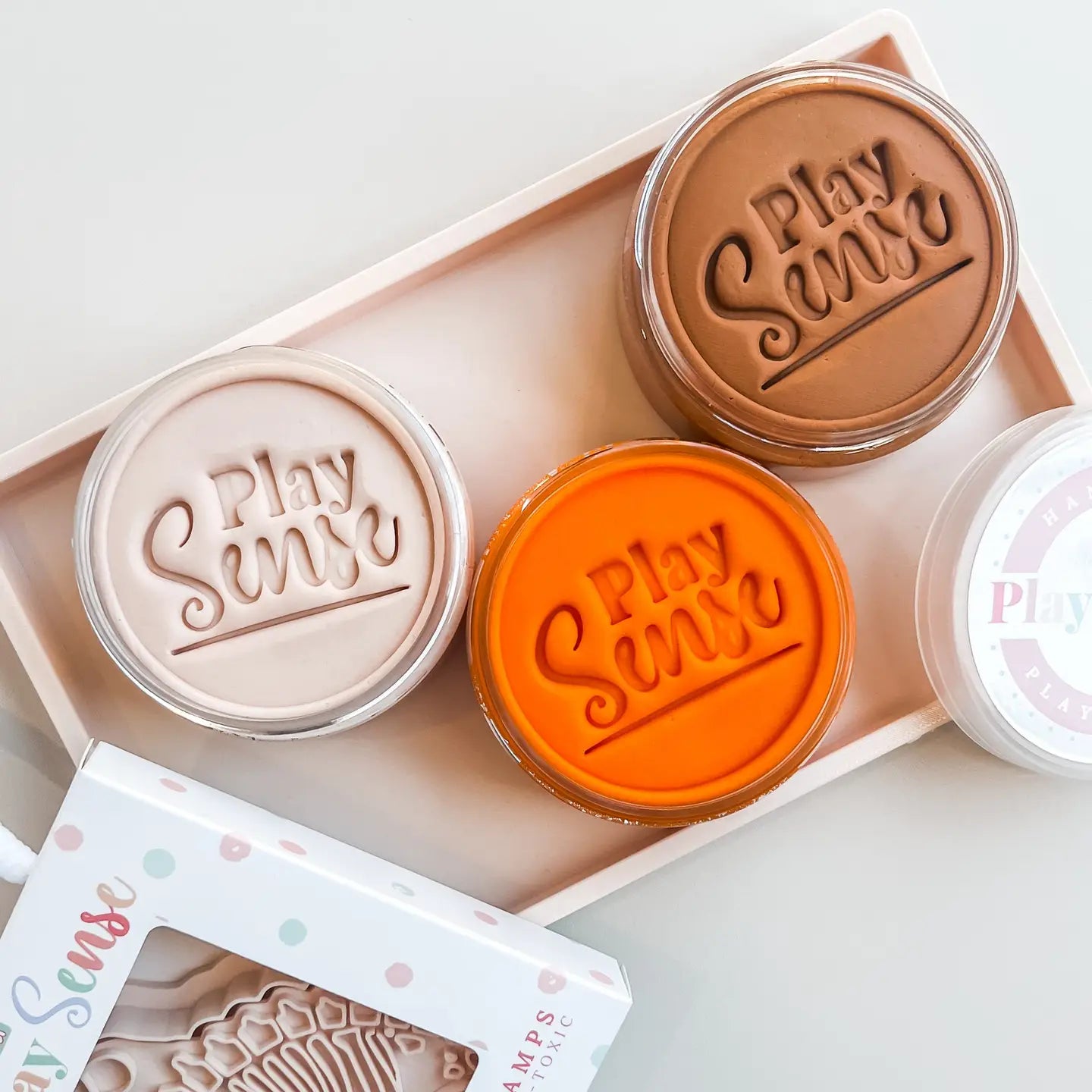 Pots of cream, brown, orange scented play dough