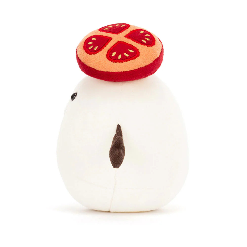 Plush toy resembling a mozzarella cheese ball with a tomato on its head against a white background