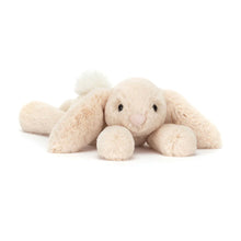 Cream-colored plush bunny toy on a white background