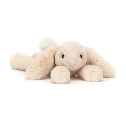 Cream-colored plush bunny toy on a white background