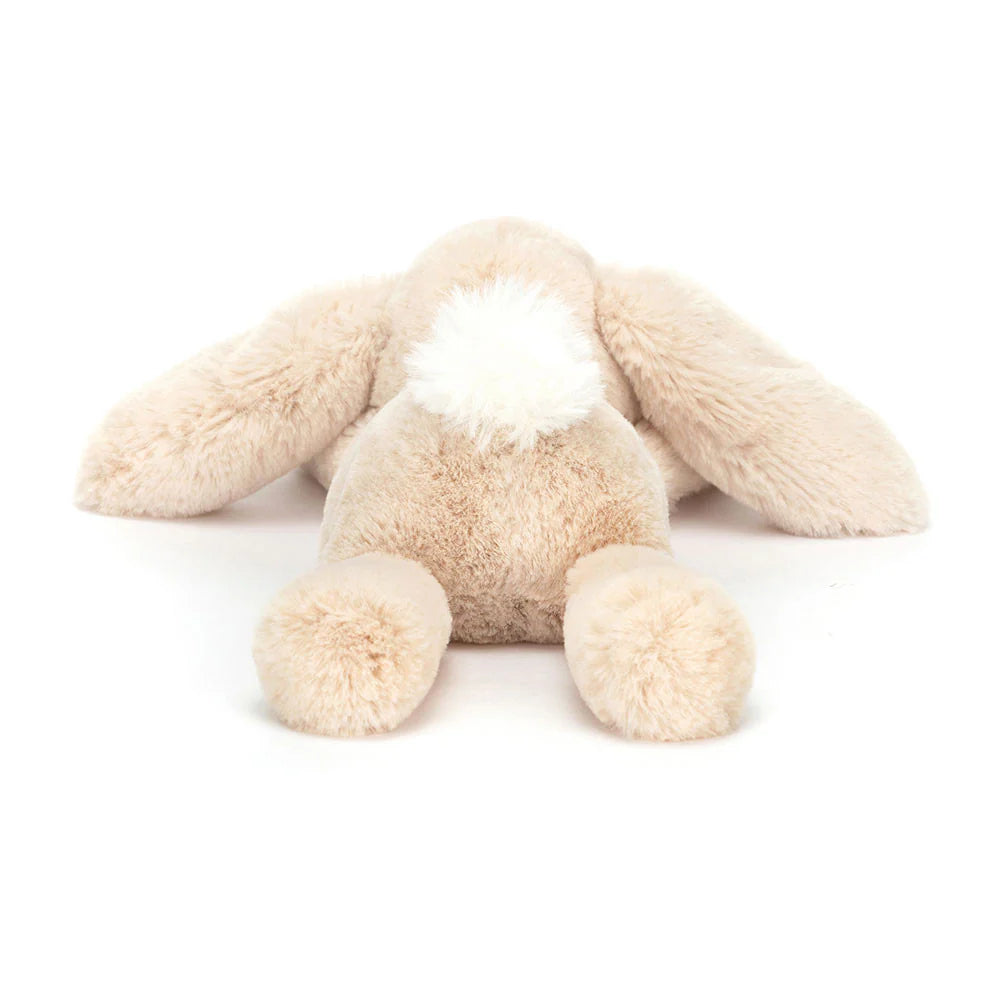 Beige plush bunny toy on a white background