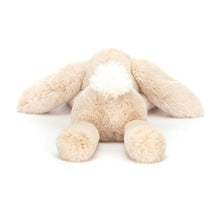 Beige plush bunny toy on a white background