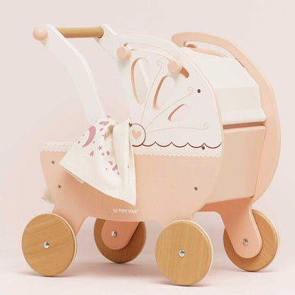 Pink and beige toy pram with a white canopy on a light pink background