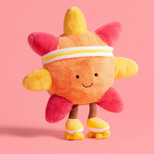 Plush toy resembling a sun with pink rays on a pink background