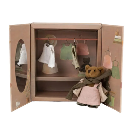 Toy wardrobe with clothes and a teddy bear on a white background