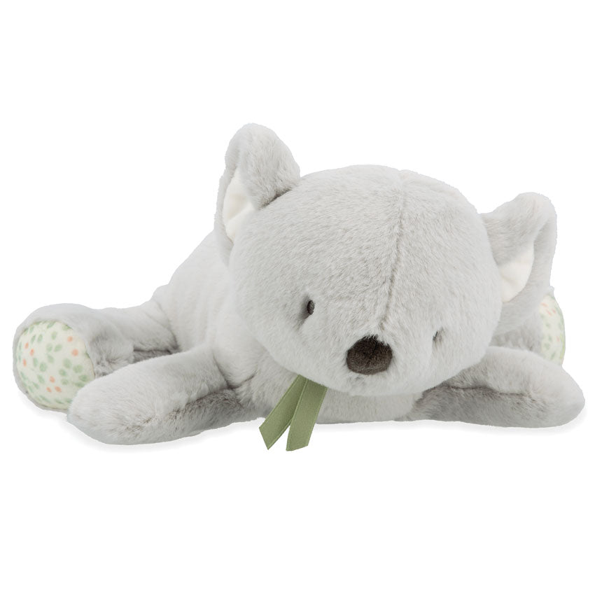 Grey koala soft toy laying on a white background
