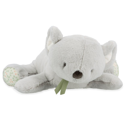 Grey koala soft toy laying on a white background