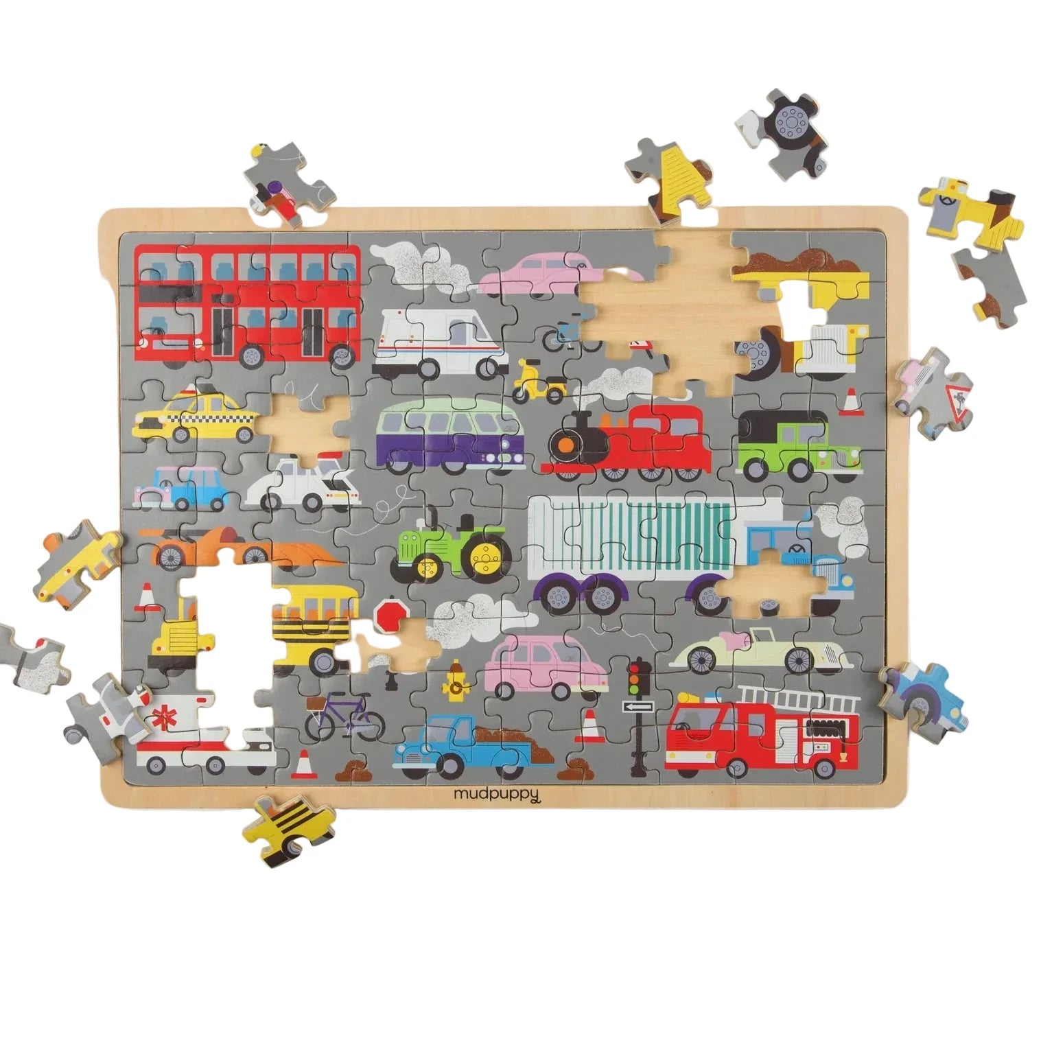 A children's wooden puzzle board featuring colorful cartoon vehicles and road elements, shown with several loose pieces around it on a white background. The brand name 'musbuddy' is printed at the bottom of the board.