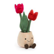 A plush toy depicting a pot with two red tulip flowers and a smiling face on the pot.
