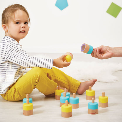 Child playing with colorful wooden toys on a light-colored floor.