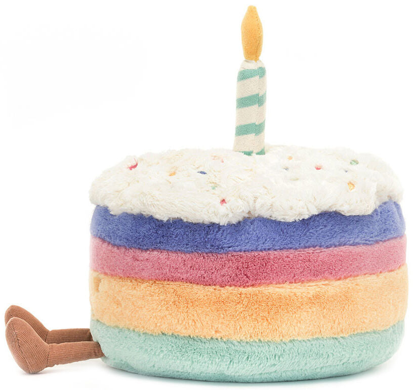 Plush toy resembling a birthday cake with a candle on a white background