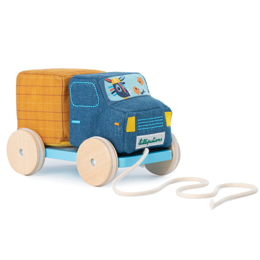 A blue and yellow fabric block truck with a wooden base and rubber wheels, designed for toddlers.