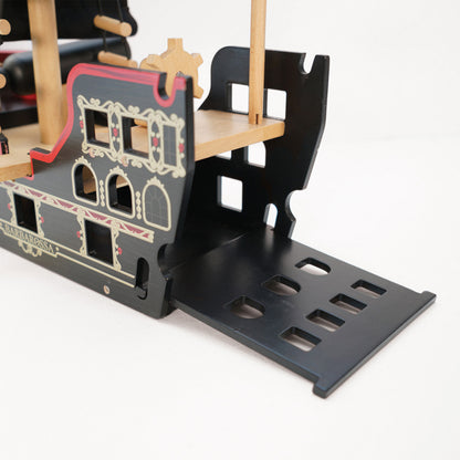 Wooden toy ship with detailed design on a white background