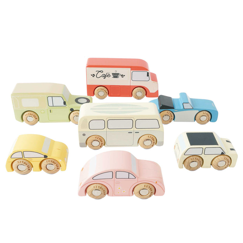 A collection of seven wooden vintage toy cars in various colors, including beige, blue, red, and yellow.
