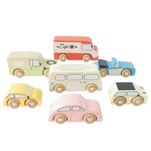 A collection of seven wooden vintage toy cars in various colors, including beige, blue, red, and yellow.