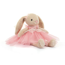 A plush toy depicting a beige bunny with pink ribbon ears, dressed in a pink ballet costume with a tutu.