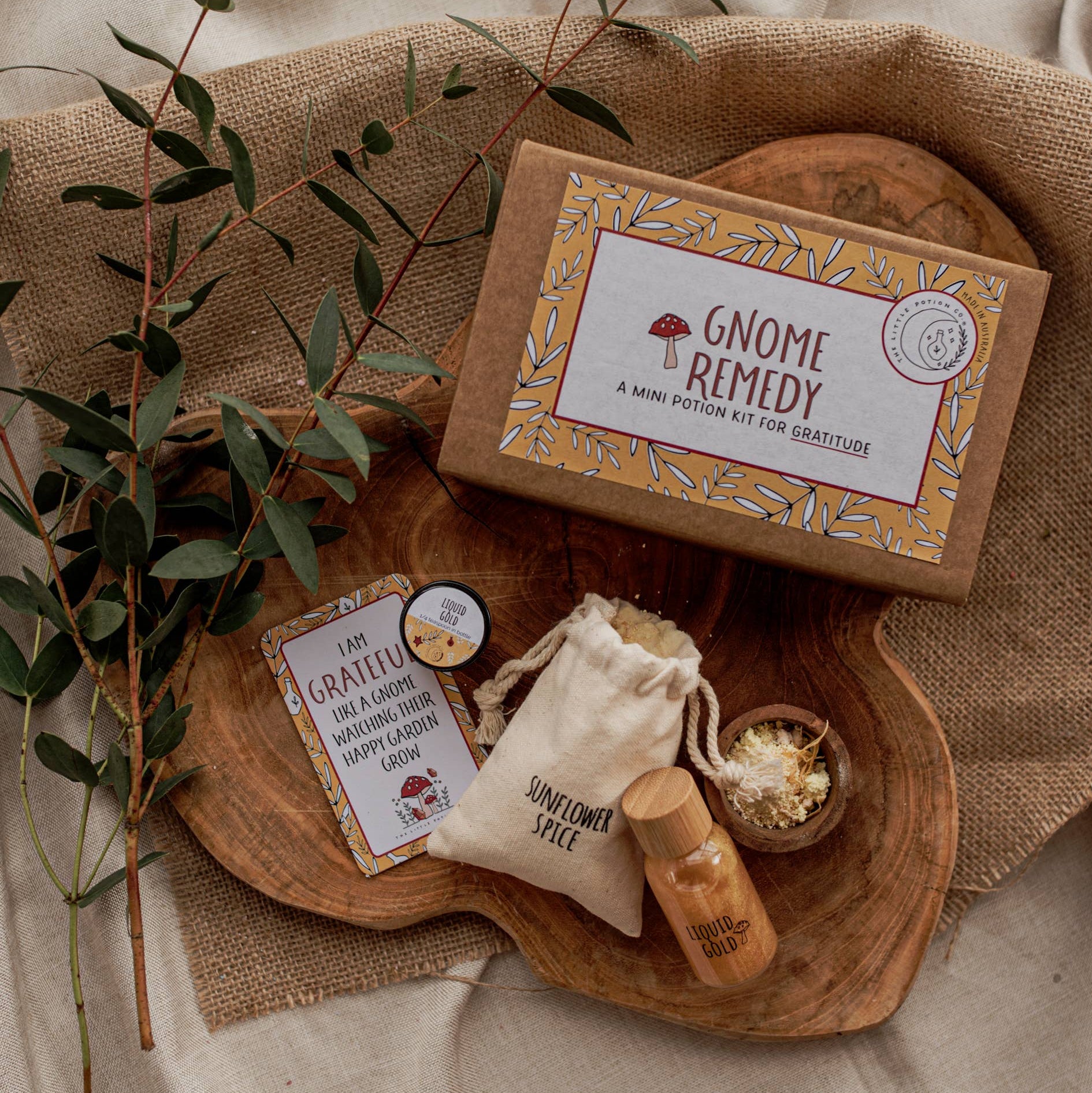 Little Potion Co Gnome Ready Potion Kit contents displayed on wooden tray with natural cloth and hessian background.