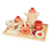 A wooden tea set toy on a tray, including a teapot, cups with saucers, spoons, a sugar pot with lid, a milk jug, and biscuits.