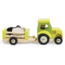 Wooden toy truck with trailer carrying animals on a white background