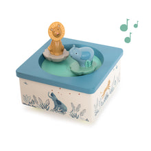 A blue and white musical box featuring a lion and an elephant, with a note indicative of a musical theme.