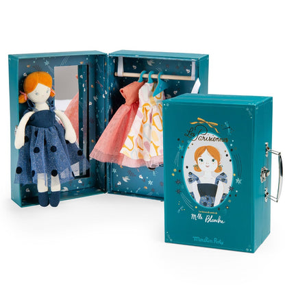 Small rag doll wearing blues tulle evening dress, with cardboard wardrobe suitcase.