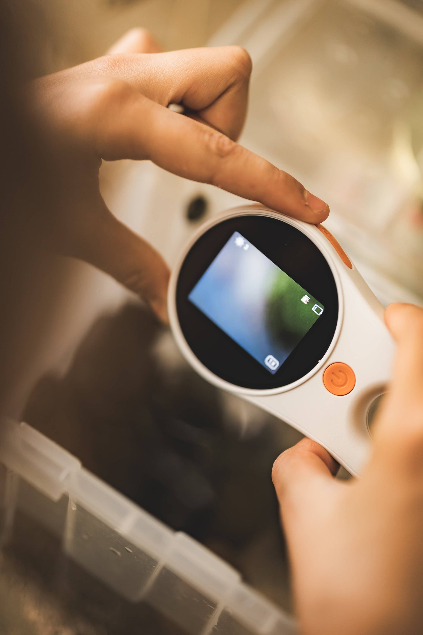 Digital microscope being held by a child with a blurred background