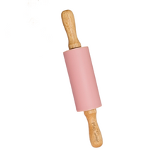 A pink rolling pin with wooden handles, designed for play dough.