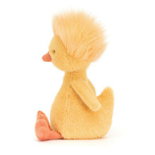 A plush toy duckling with bold yellow fur and a funky yellow hairdo, featuring little wings, a high tail, a soft orange beak, and matching long legs.