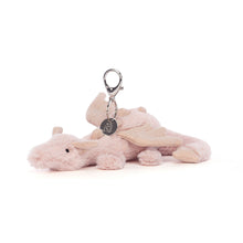 A plush rose dragon bag charm with a silver claw clip and glitter jersey wings, spines, and ears.