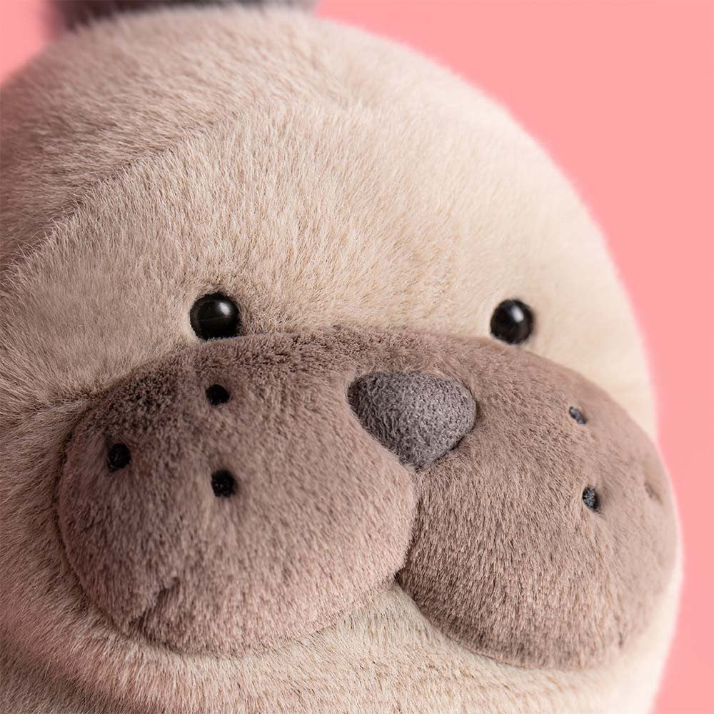 Close-up of a plush toy with a pink background