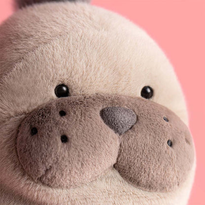 Close-up of a plush toy with a pink background