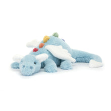 A plush toy resembling a dragon with a sky-blue body, white wings, and multicolored spine.