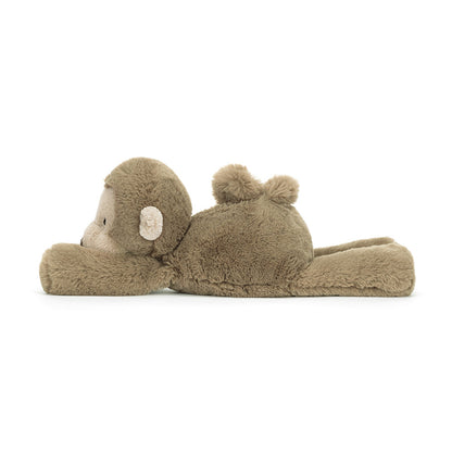 Brown monkey plush toy lying on a white background