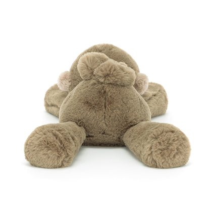 Plush toy resembling a monkey with pom-pom ears on a white background