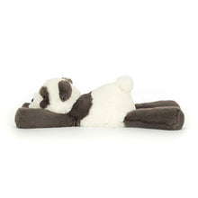 Plush panda toy lying on a white background