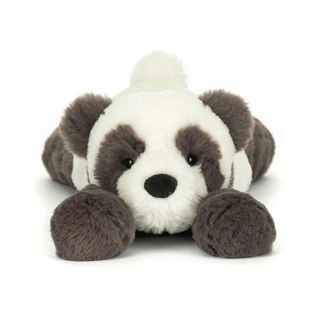 Plush toy panda lying on a white background