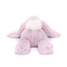 A plush toy resembling a lavender-colored rabbit with a fluffy cream bobtail and soft ears.