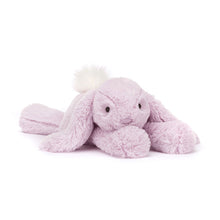 A plush toy resembling a lavender-colored rabbit with a fluffy cream bobtail, soft ears, and a small nose detail.