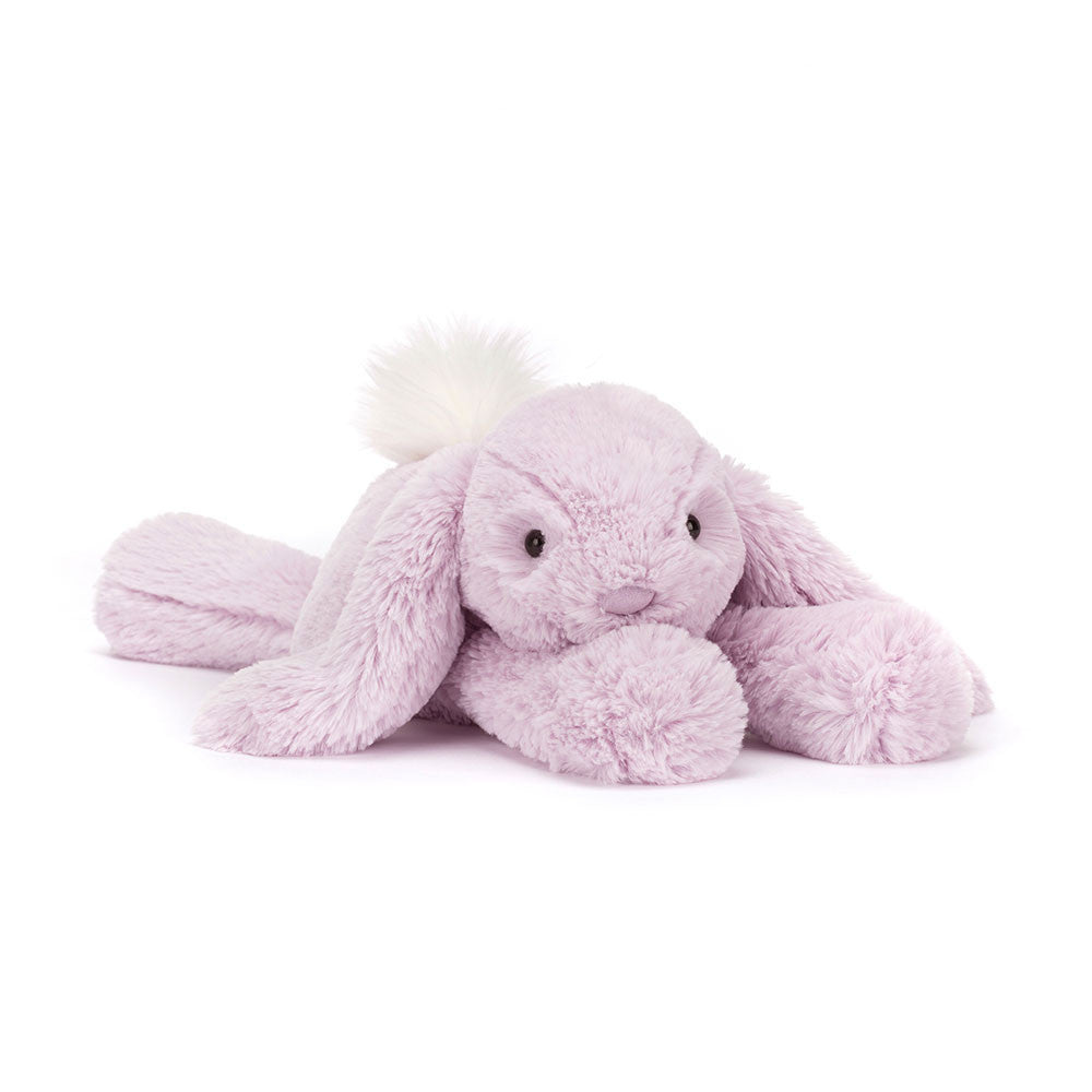 A plush toy resembling a lavender-colored rabbit with a fluffy cream bobtail, soft ears, and a small nose detail.