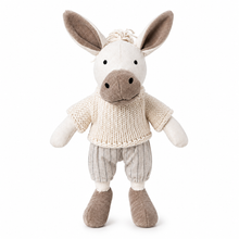 A plush stuffed animal shaped like a donkey, wearing a cream knit short-sleeve top and light gray pinstriped pants, photographed against a plain white background.