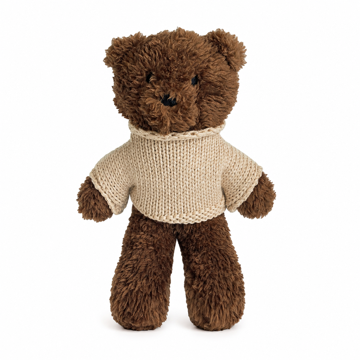 Brown teddy bear wearing an oat colour knitted sweater, standing against a white background.