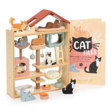 Wooden cat toy house with cat figures and 'Cat Files' book on a white background