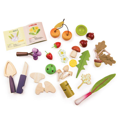 Set of wooden toy fruits, vegetables, and gardening tools on a white background
